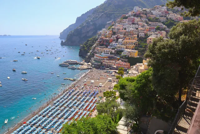 A stunning aerial view of Positano's vibrant coastline, showcasing its colorful buildings and azure sea.