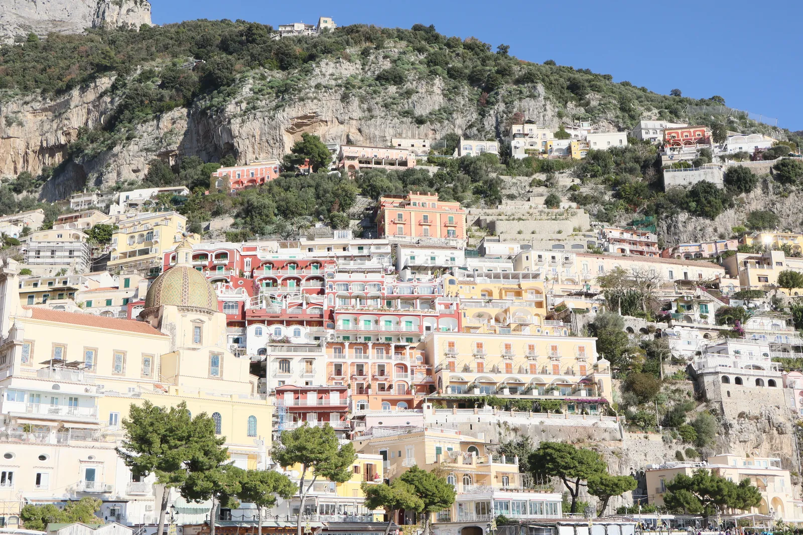 A vibrant display of Positano's colorful cliffside homes against the rocky terrain in Campania, Italy.
