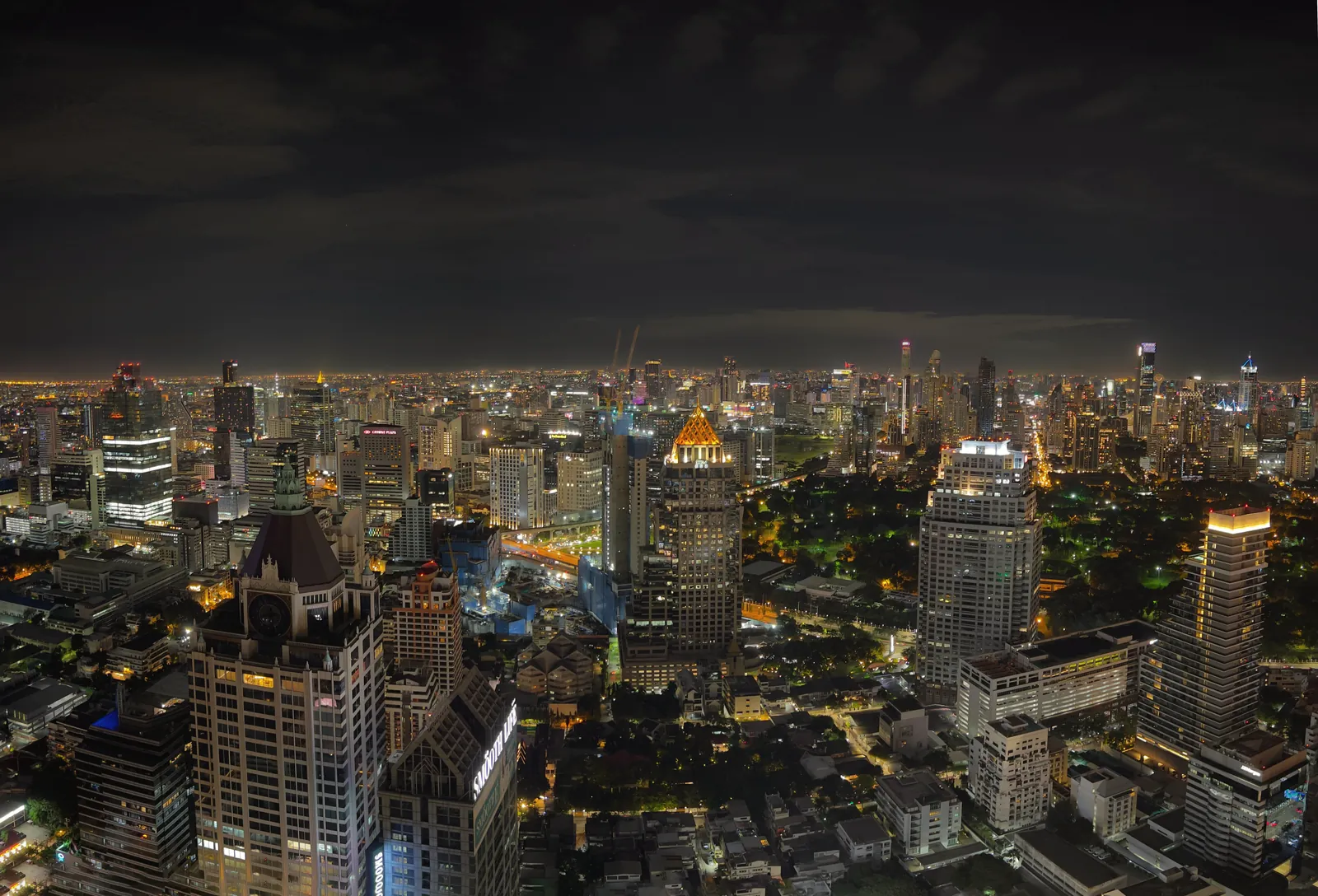 A breathtaking aerial view of Bangkok's vibrant cityscape illuminated at night.