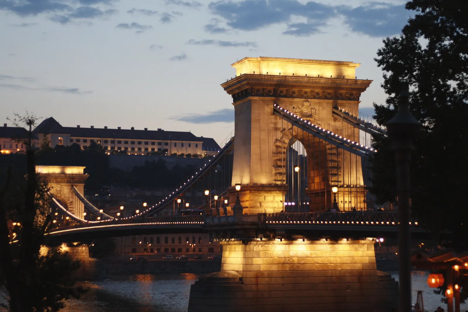 The iconic Chain Bridge in Budapest beautifully lit against the evening sky, showcasing architectural elegance.