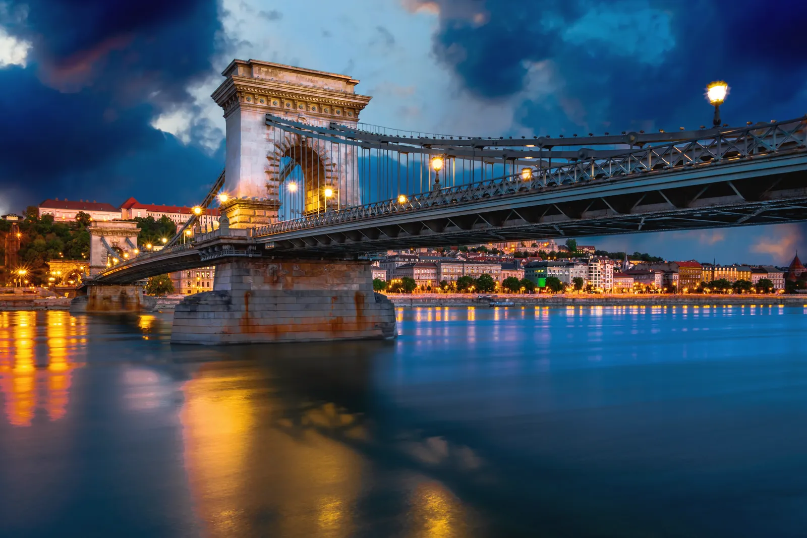 Night view of Széchenyi Chain Bridge illuminated over the Danube River in Budapest, Hungary.