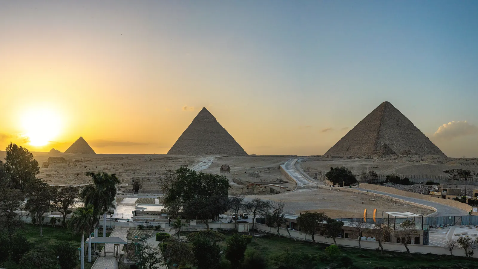 Breathtaking view of the Pyramids of Giza at sunset, capturing ancient history and stunning landscape.