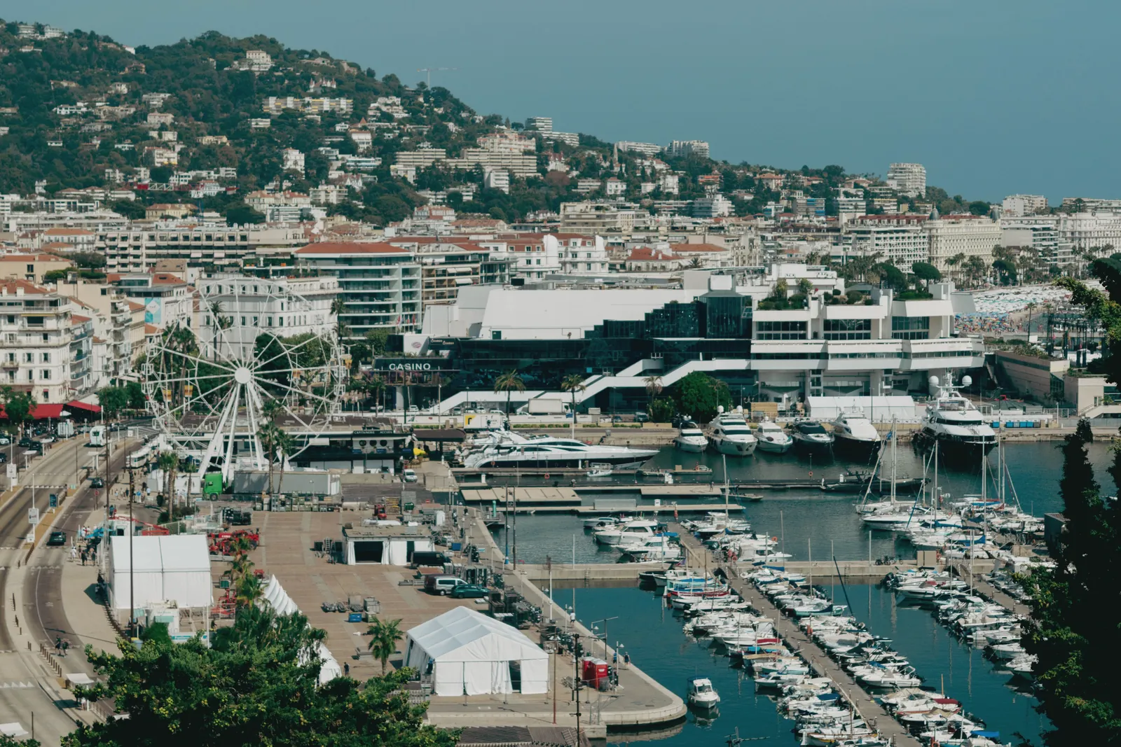 Scenic aerial shot of Cannes harbor with yachts and cityscape, capturing the essence of the French Riviera.