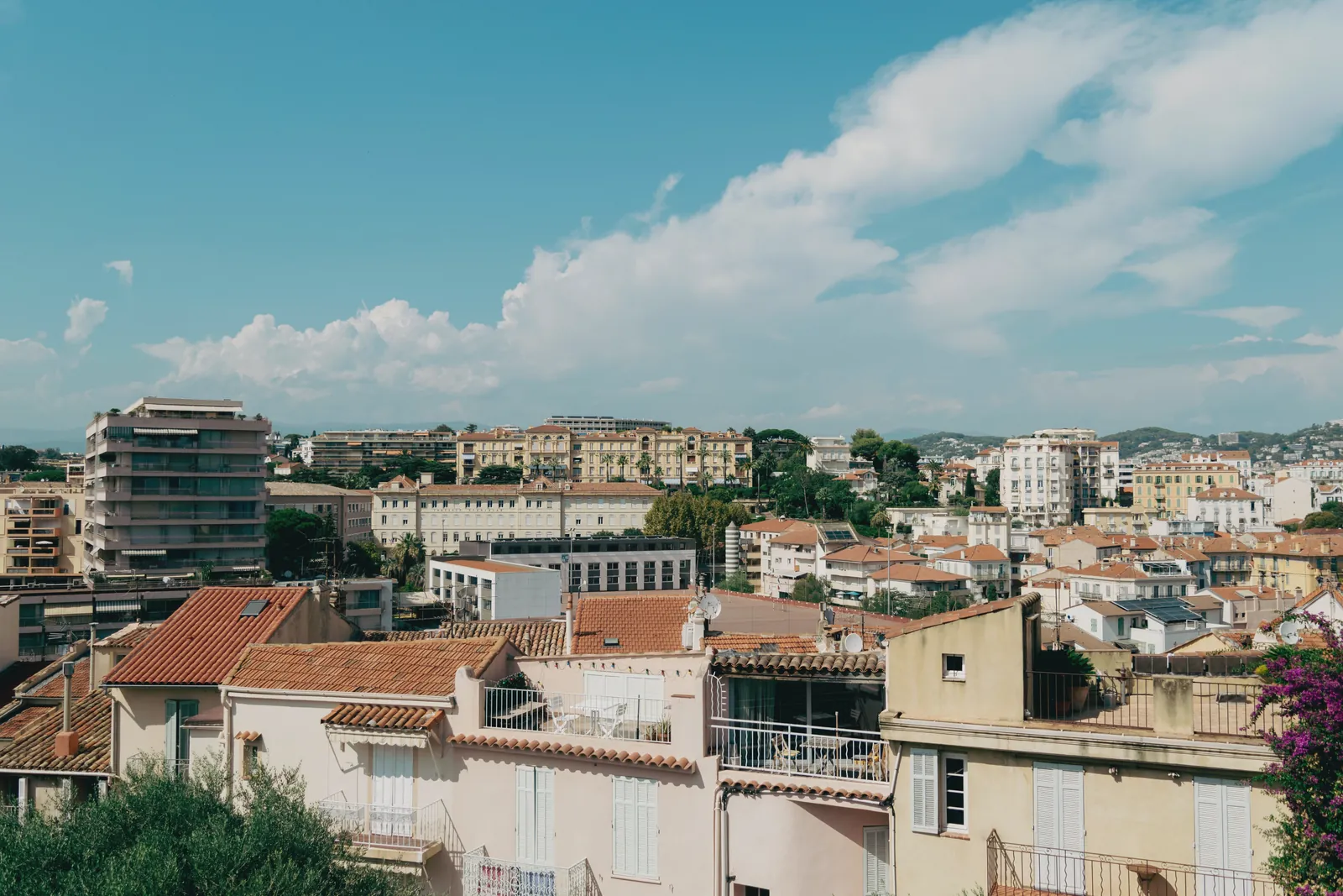 Explore the charming rooftops of Cannes, showcasing the city's Mediterranean architecture under a clear blue sky.