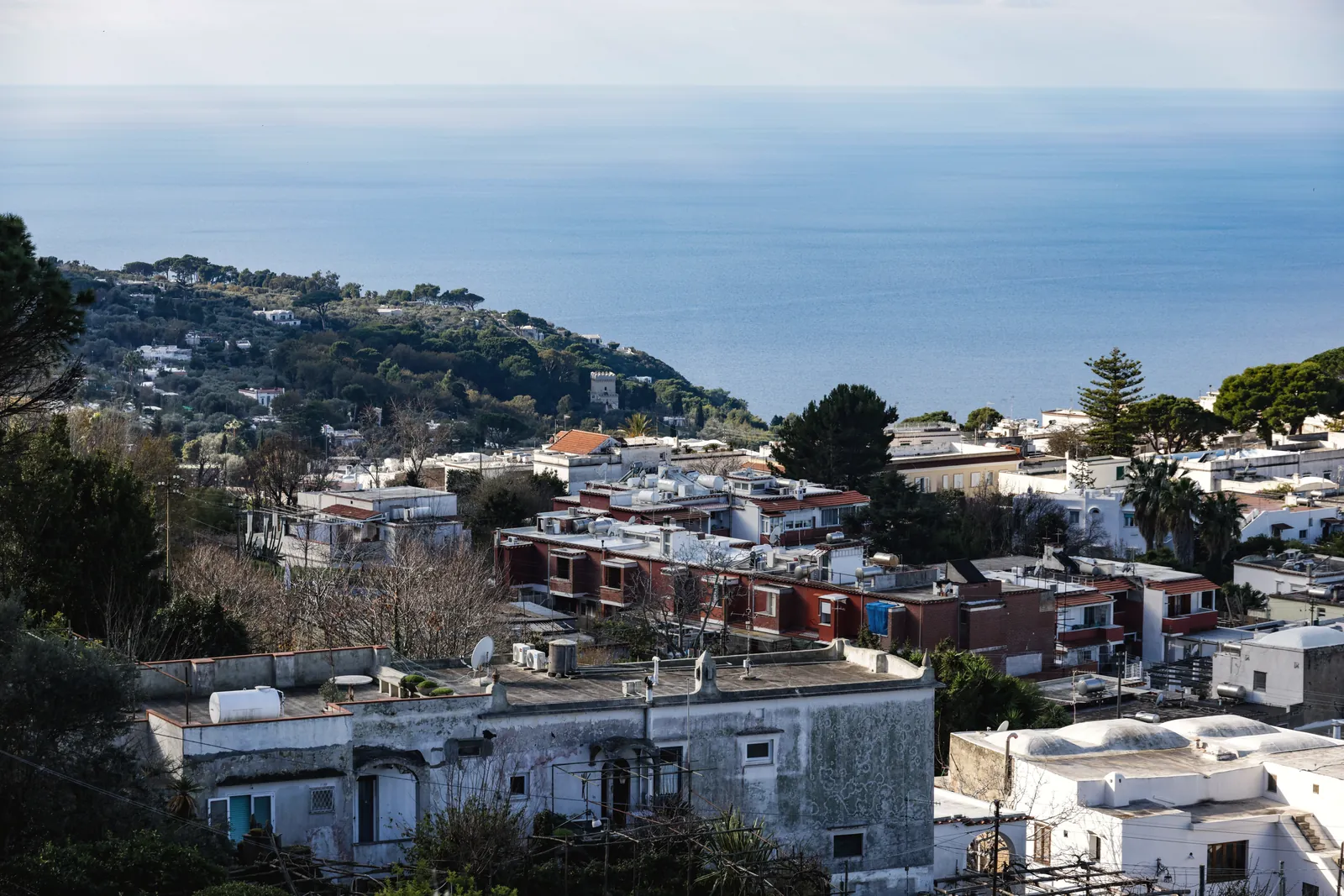 Aerial view of Capri's coastline with Mediterranean Sea backdrop and charming Italian architecture.