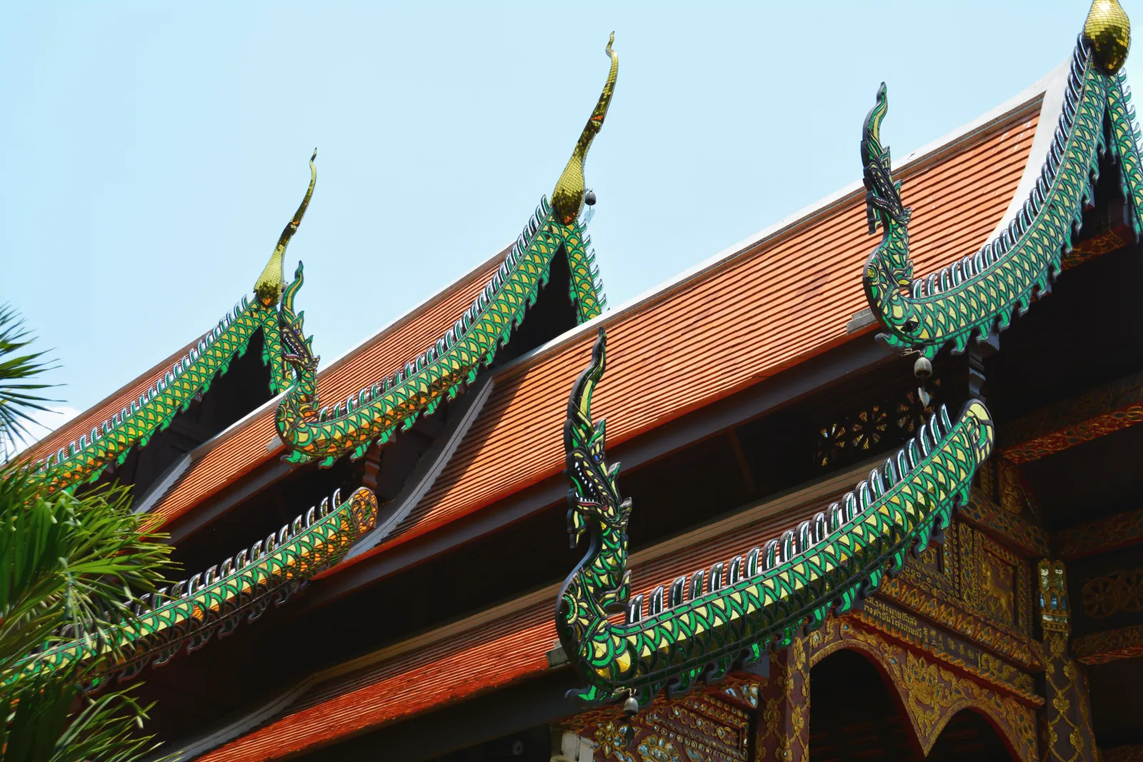 Detailed view of ornate roof decorations on a traditional Thai temple.