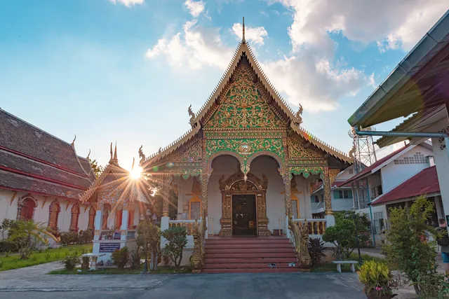 Beautiful ornate temple facade with sunburst at Wat Chiang Man, showcasing traditional Thai architecture.