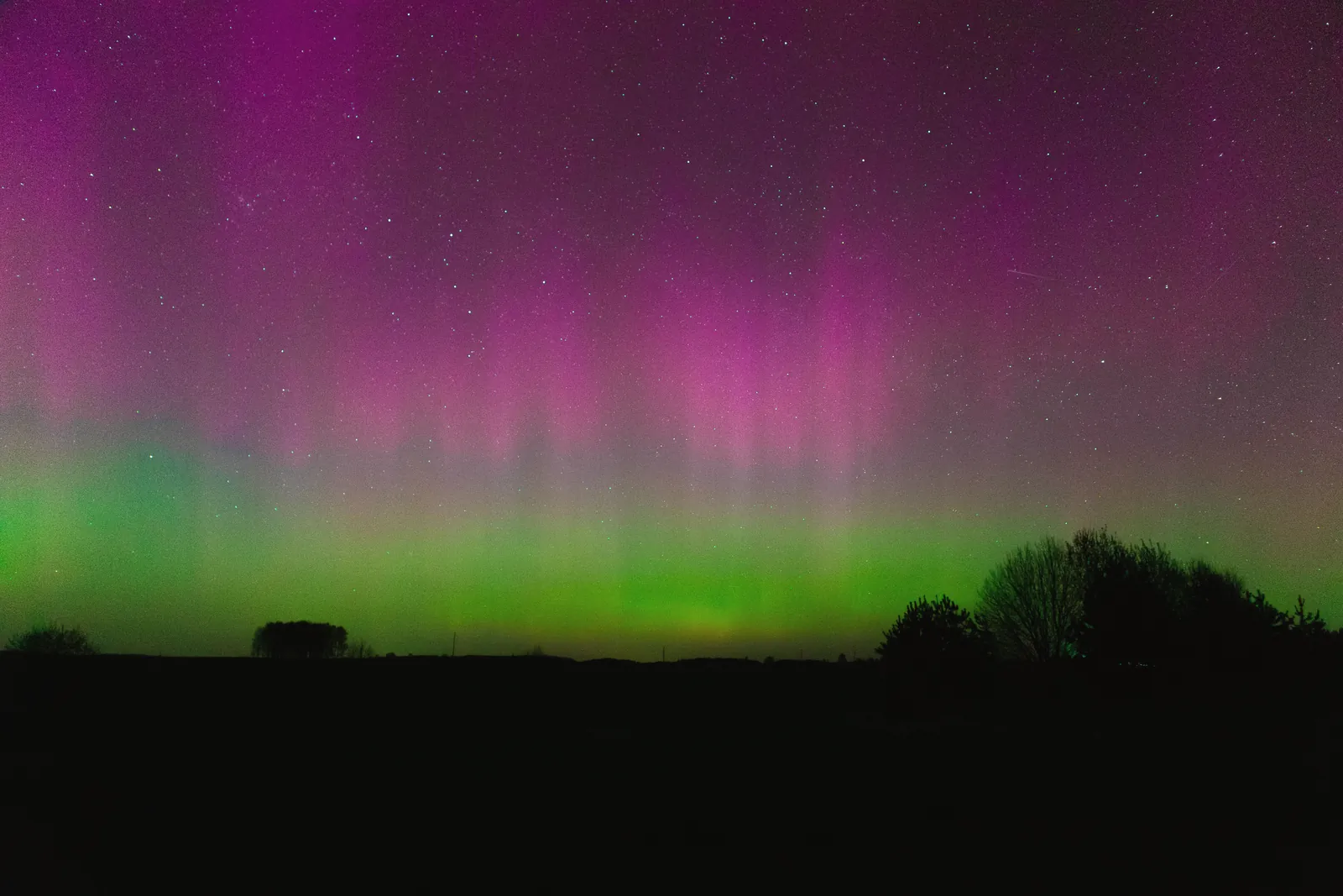 Beautiful aurora borealis lights up the night sky with vibrant colors and stars.