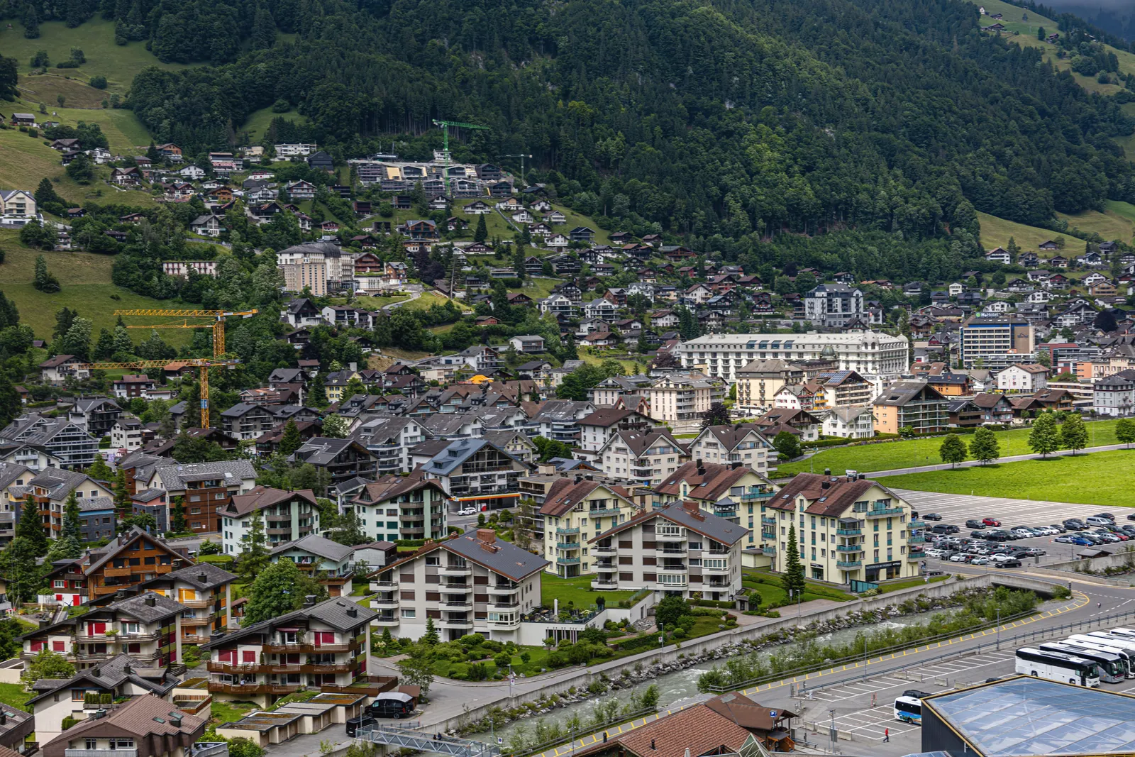 A beautiful aerial view of Engelberg, Switzerland showcasing charming houses and lush mountains.