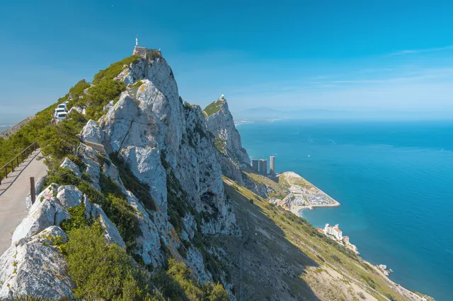 Stunning landscape of the Rock of Gibraltar with a clear blue sky and ocean.