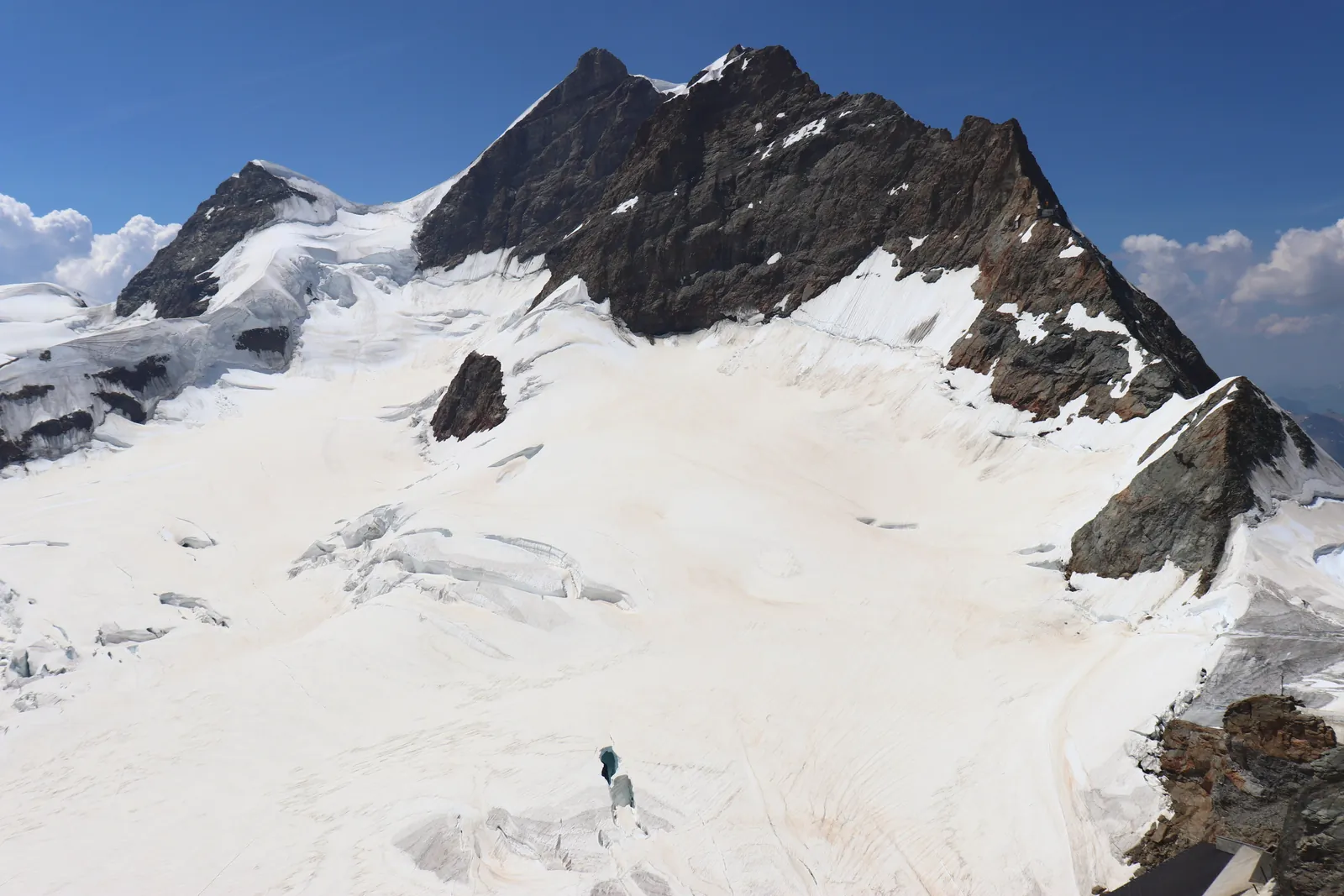 Breathtaking view of a snow-covered mountain peak in Grindelwald, Switzerland under a clear blue sky.
