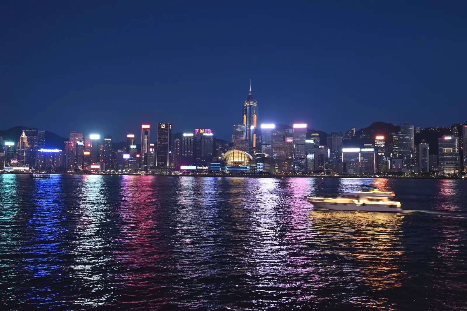 A stunning night view of Hong Kong's illuminated skyline reflecting on Victoria Harbour.