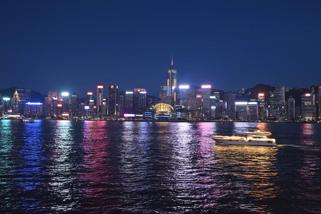 A stunning night view of Hong Kong's illuminated skyline reflecting on Victoria Harbour.
