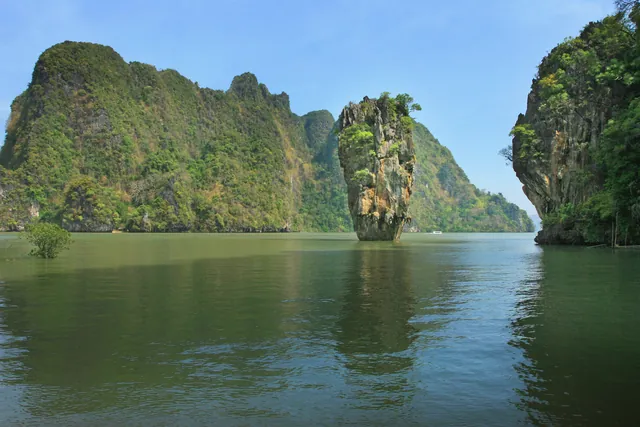 Tranquil view of James Bond Island in Thailand showcasing towering limestone cliffs and serene waters.