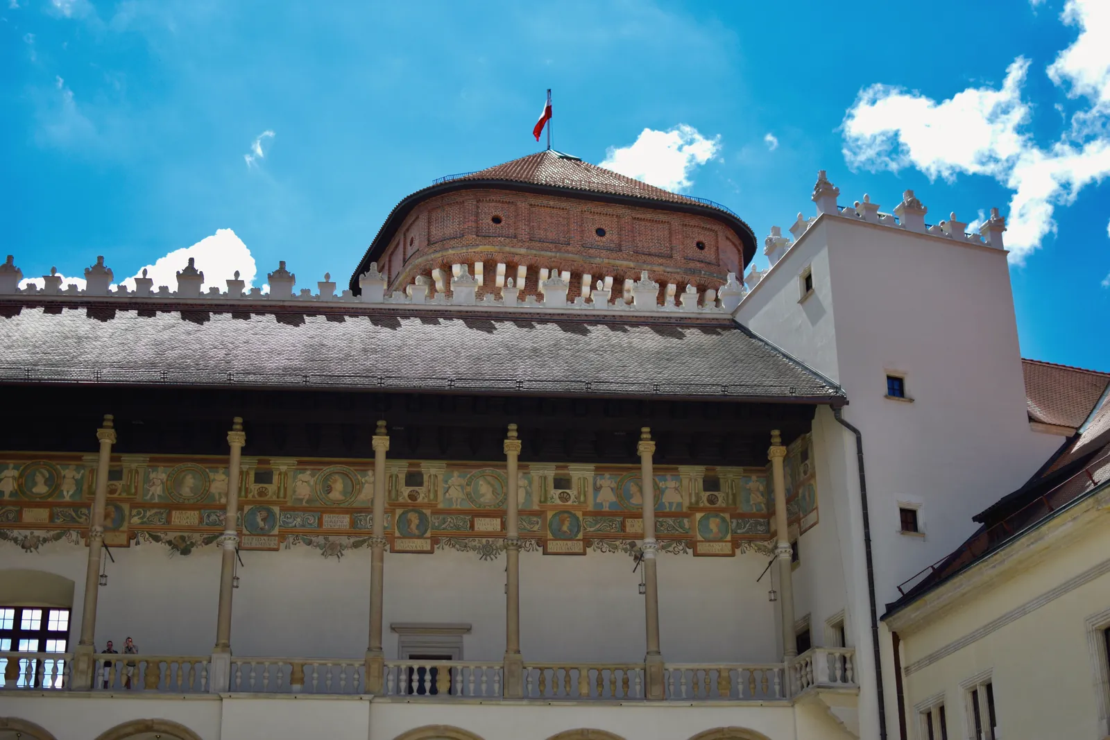 View of the ornate Wawel Castle architecture against a clear blue sky in Kraków, Poland.