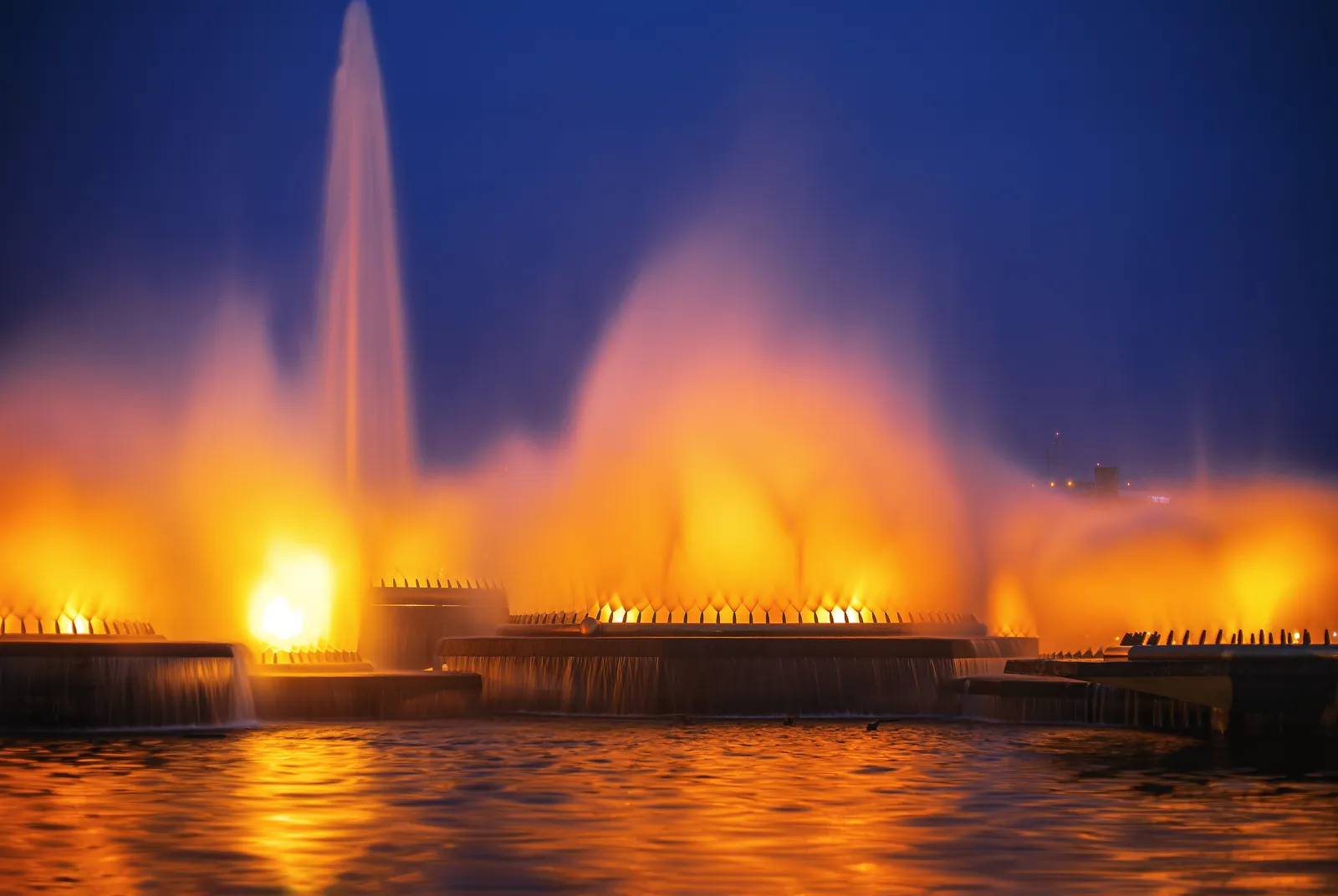 Vibrant illuminated fountains create a stunning night scene in Brasília, Brazil.