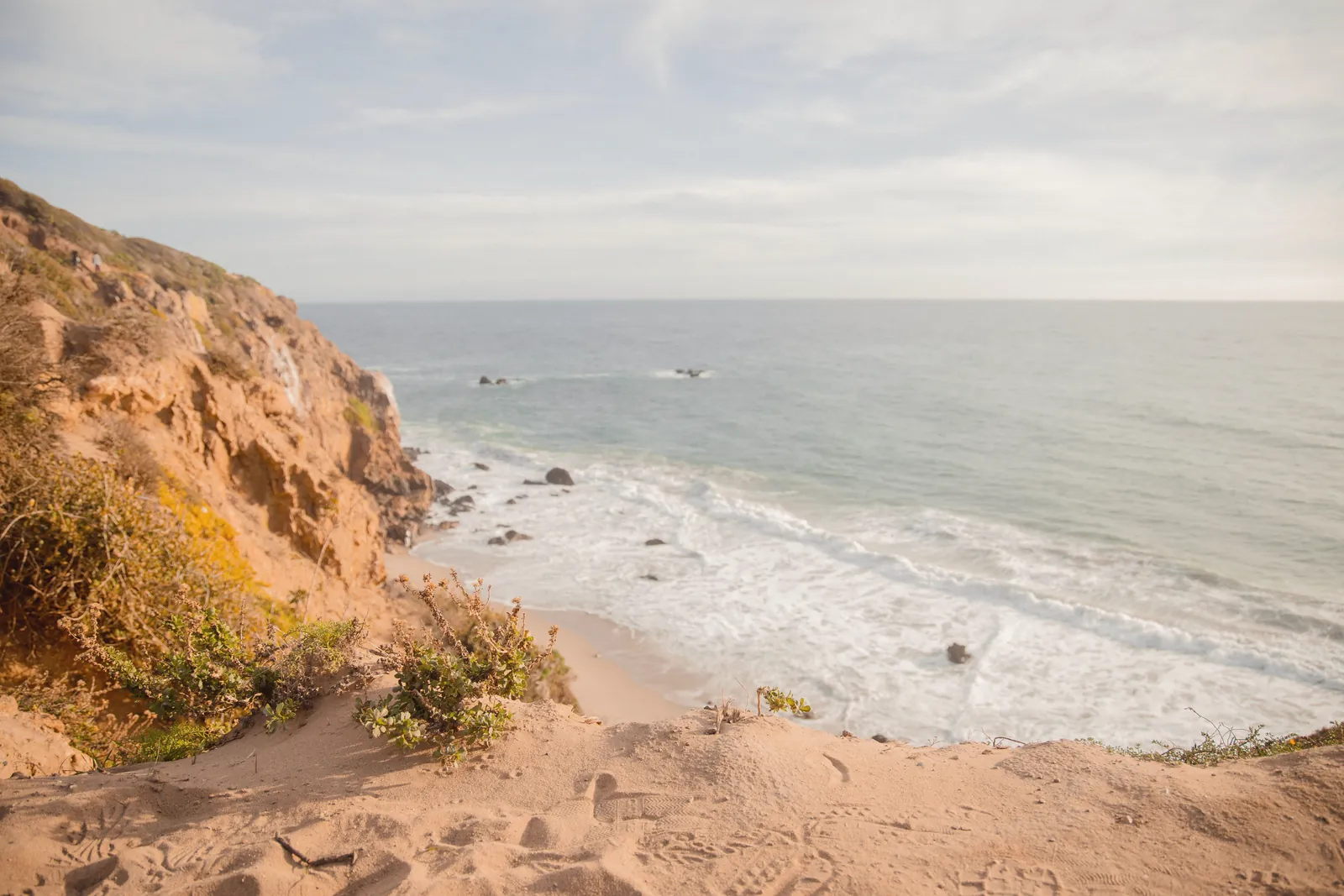 Explore the stunning cliffs and ocean horizon in Malibu on a sunny day.