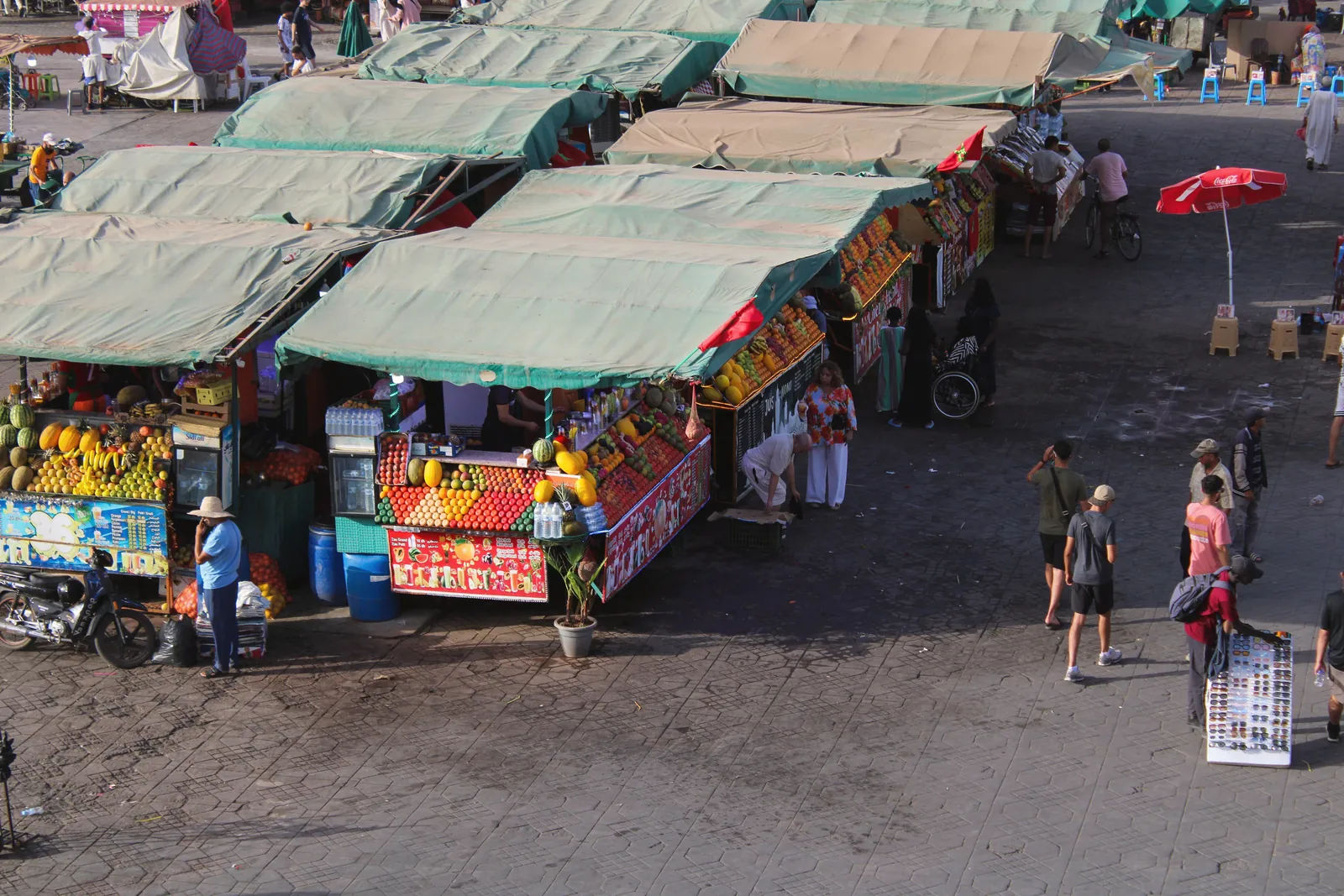 Colorful Moroccan souk stalls in Marrakech bustling with local vendors and fresh produce.
