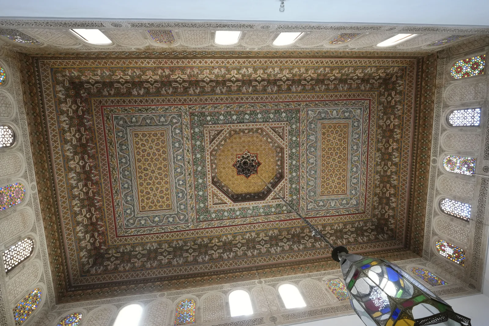 Detailed view of a richly decorated ceiling in Marrakesh showcasing traditional Moroccan design.