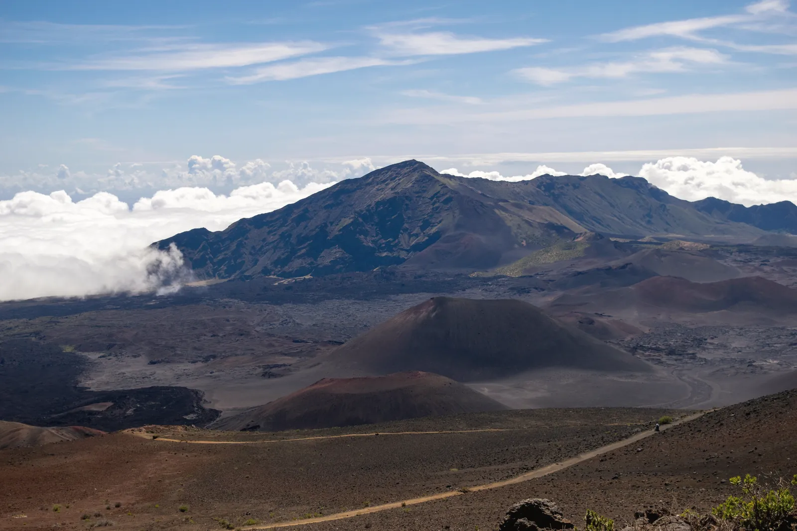 Breathtaking view of the Haleakalā volcano crater under a clear blue sky in Maui, Hawaii.