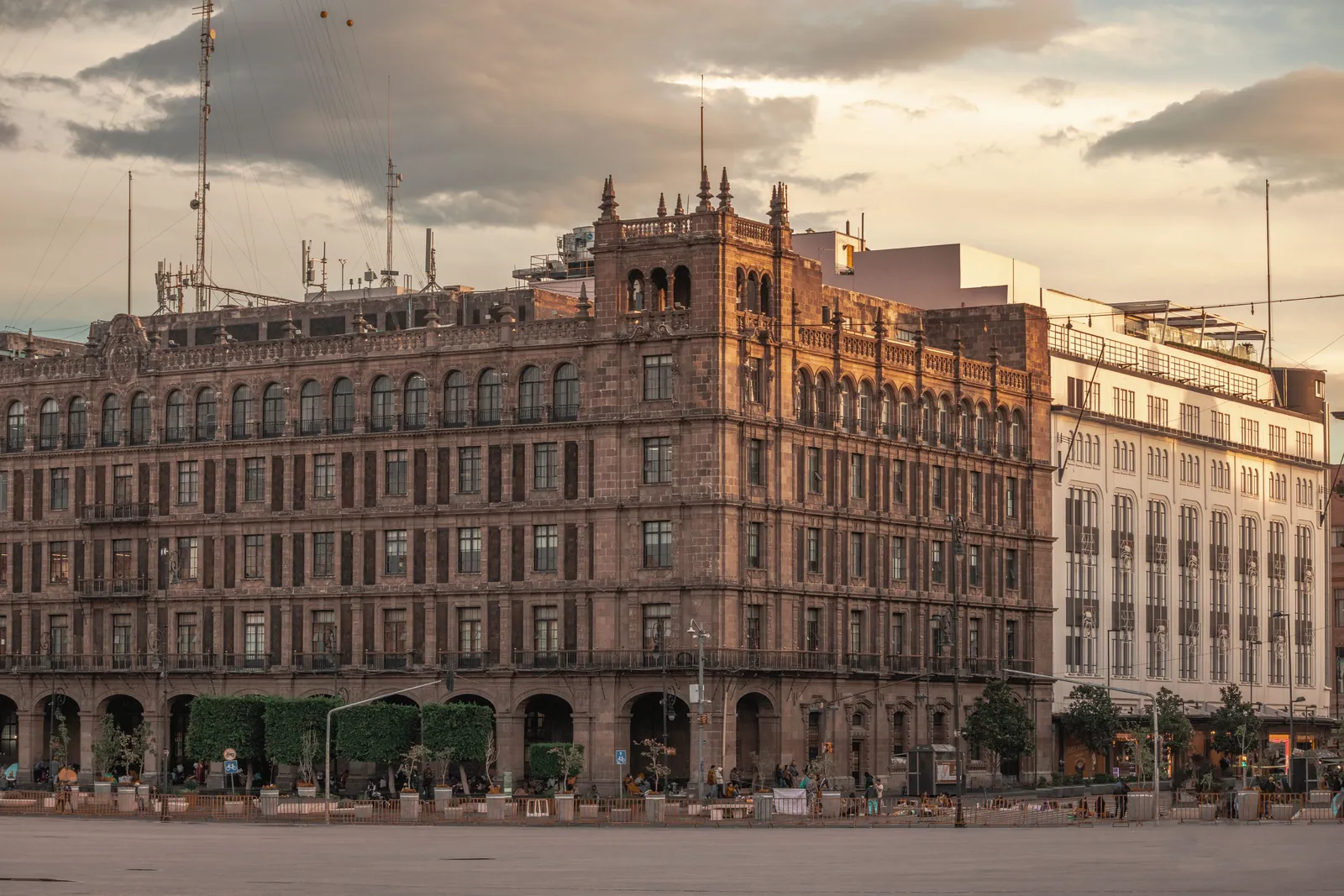 A beautiful view of a historic building in Mexico City at sunset, showcasing its architectural details.
