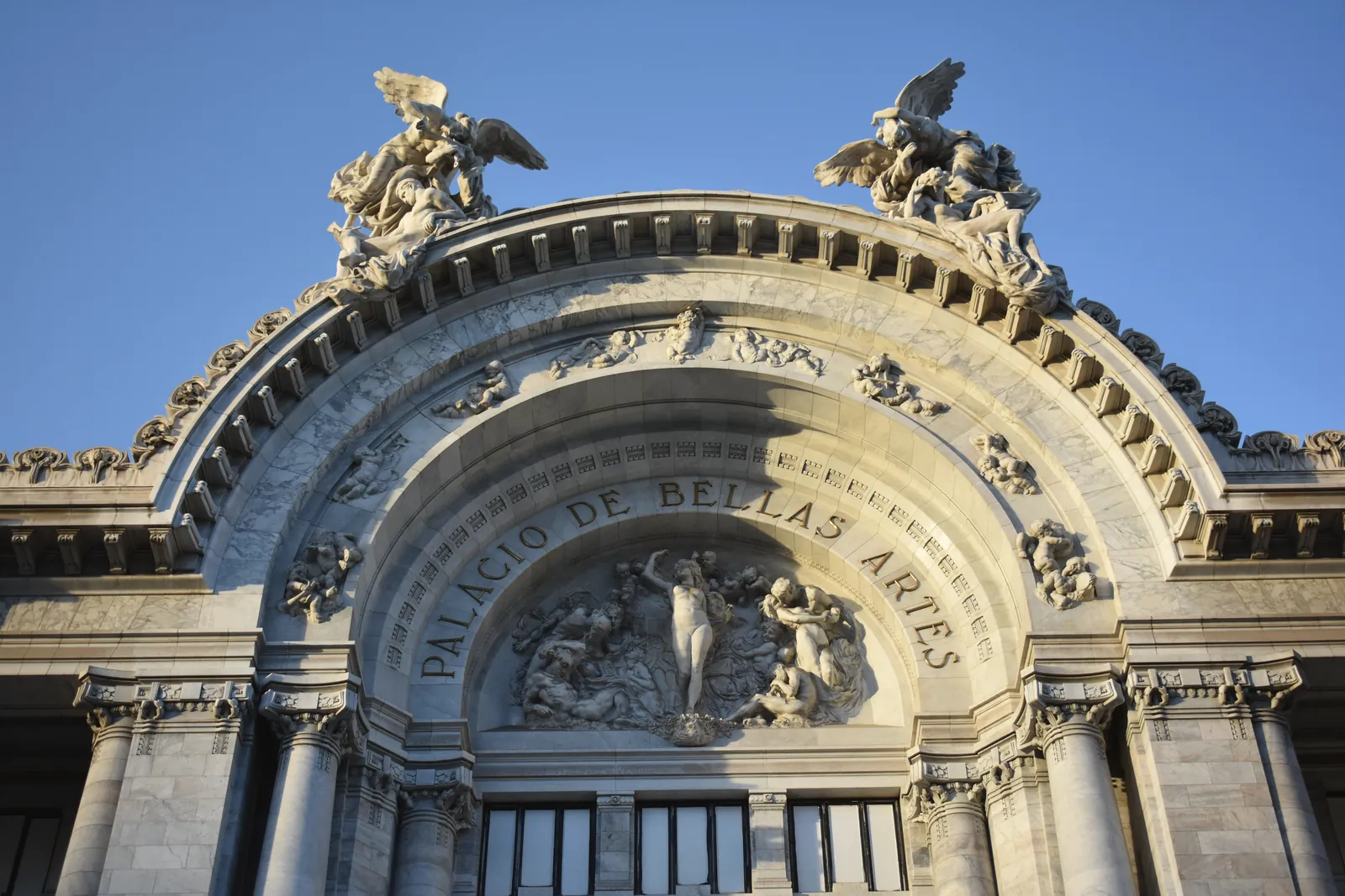 Detailed view of the ornate facade of Palacio de Bellas Artes in Mexico City showcasing neoclassical architecture.