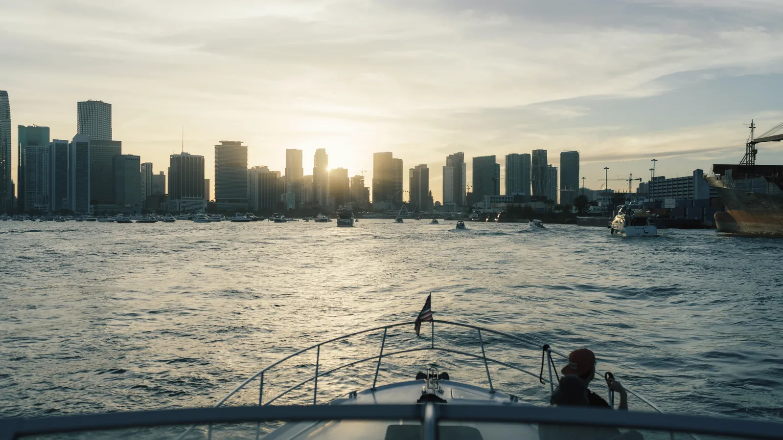Enjoy a serene boat ride with Miami's iconic skyline at sunset, offering a perfect urban escape.