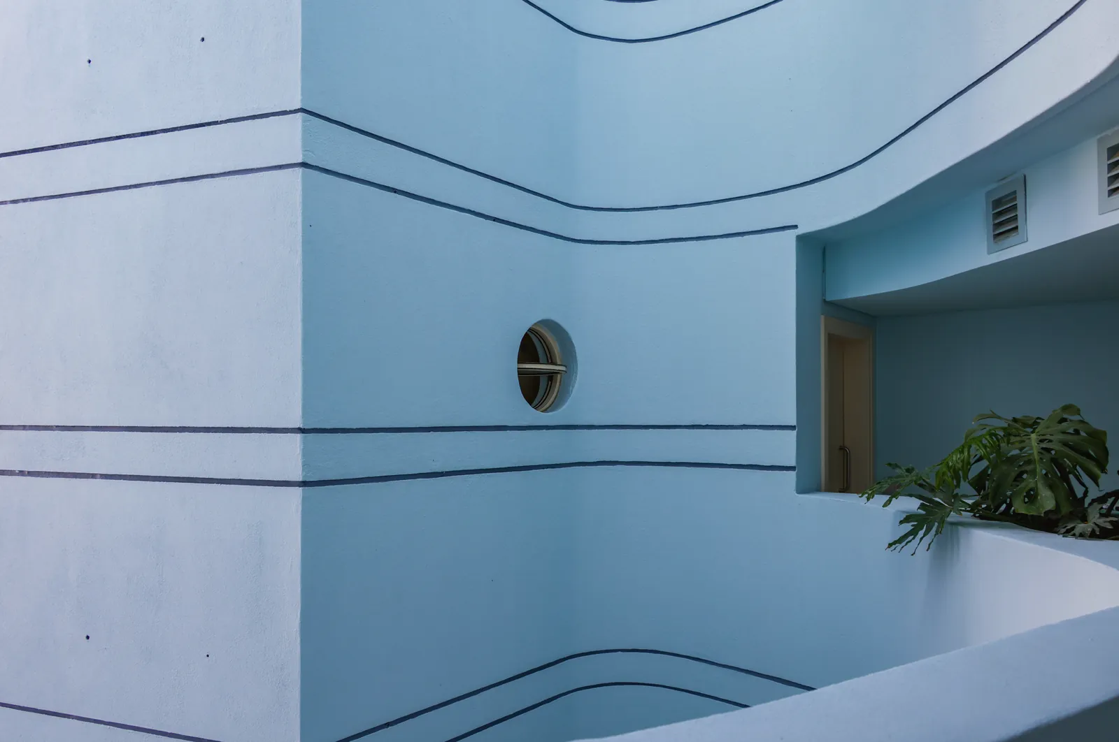 A modern architectural design featuring blue walls and unique lines, highlighting minimalist style.