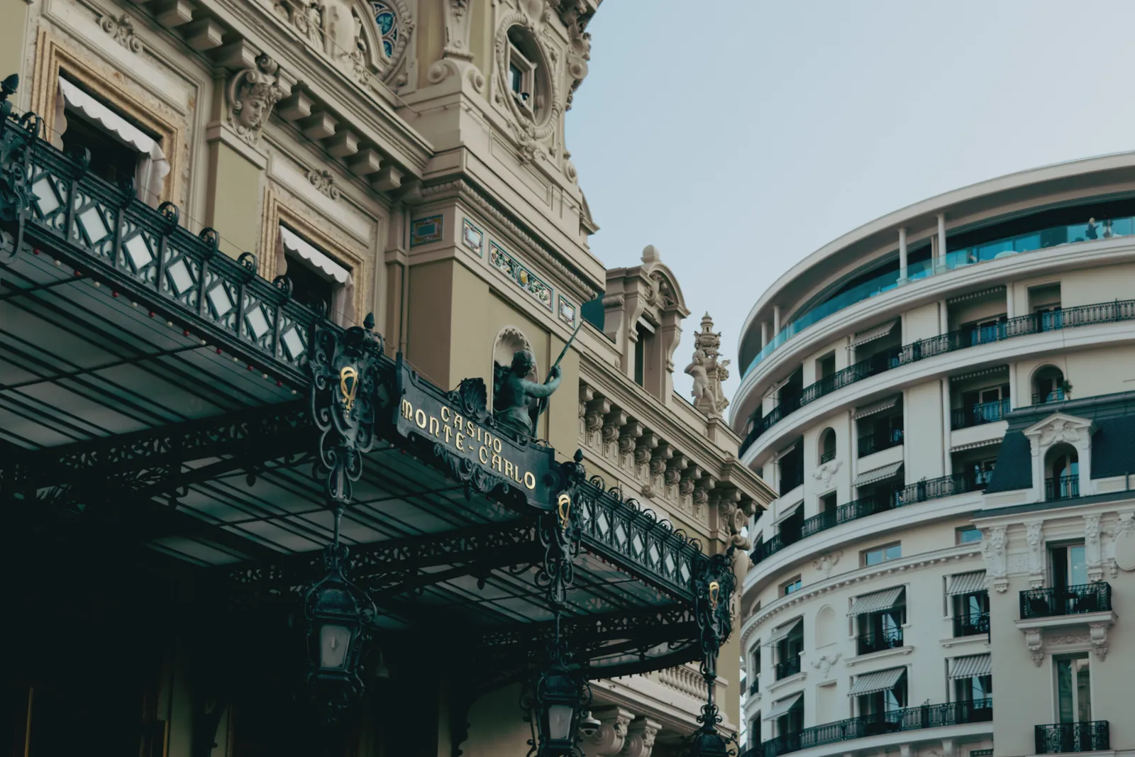 Elegant architecture of Monte Carlo Casino and nearby building in sunny Monaco.