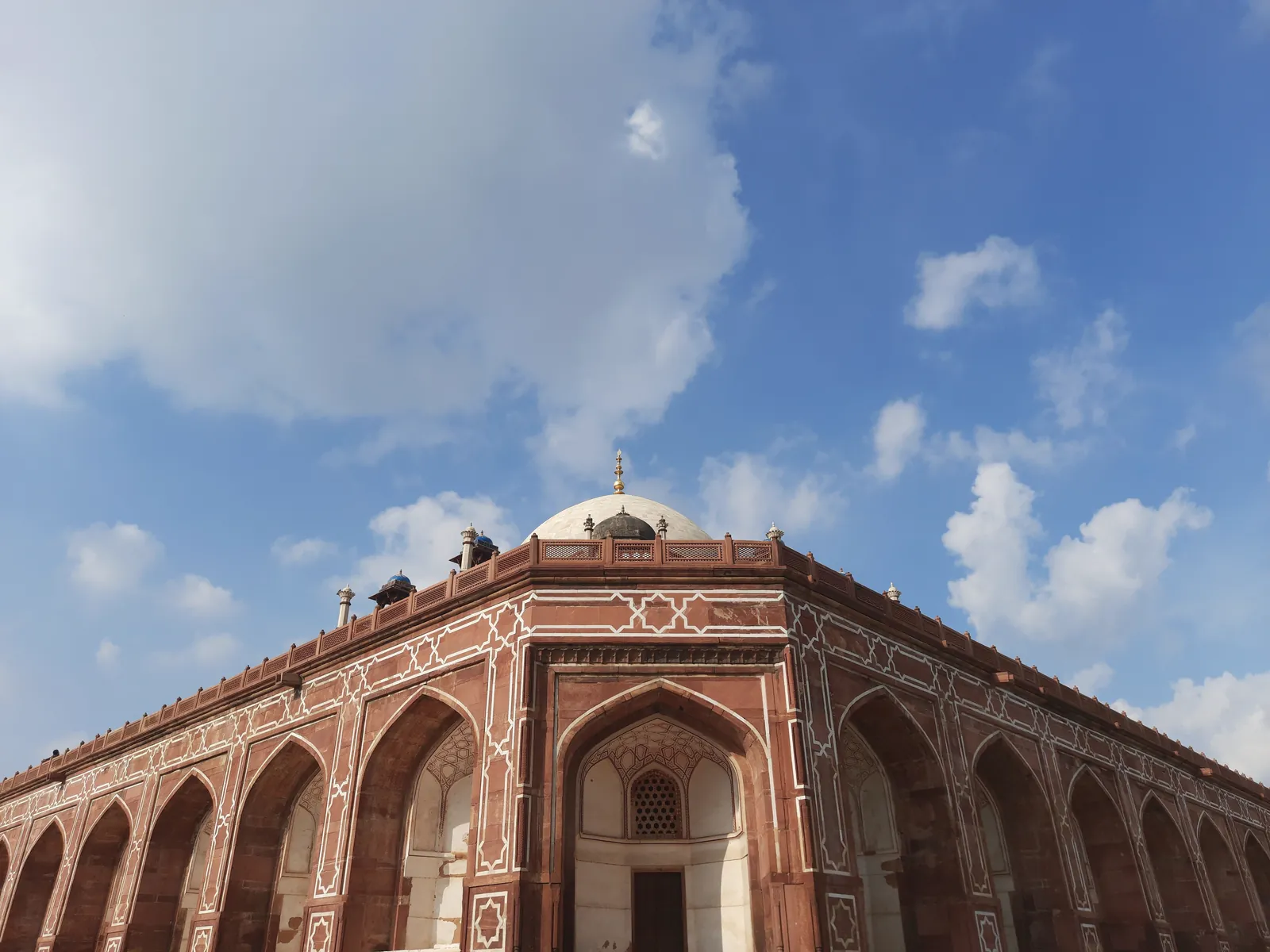 Majestic view of Humayun's Tomb in Delhi, capturing its stunning Mughal architecture under a clear blue sky.