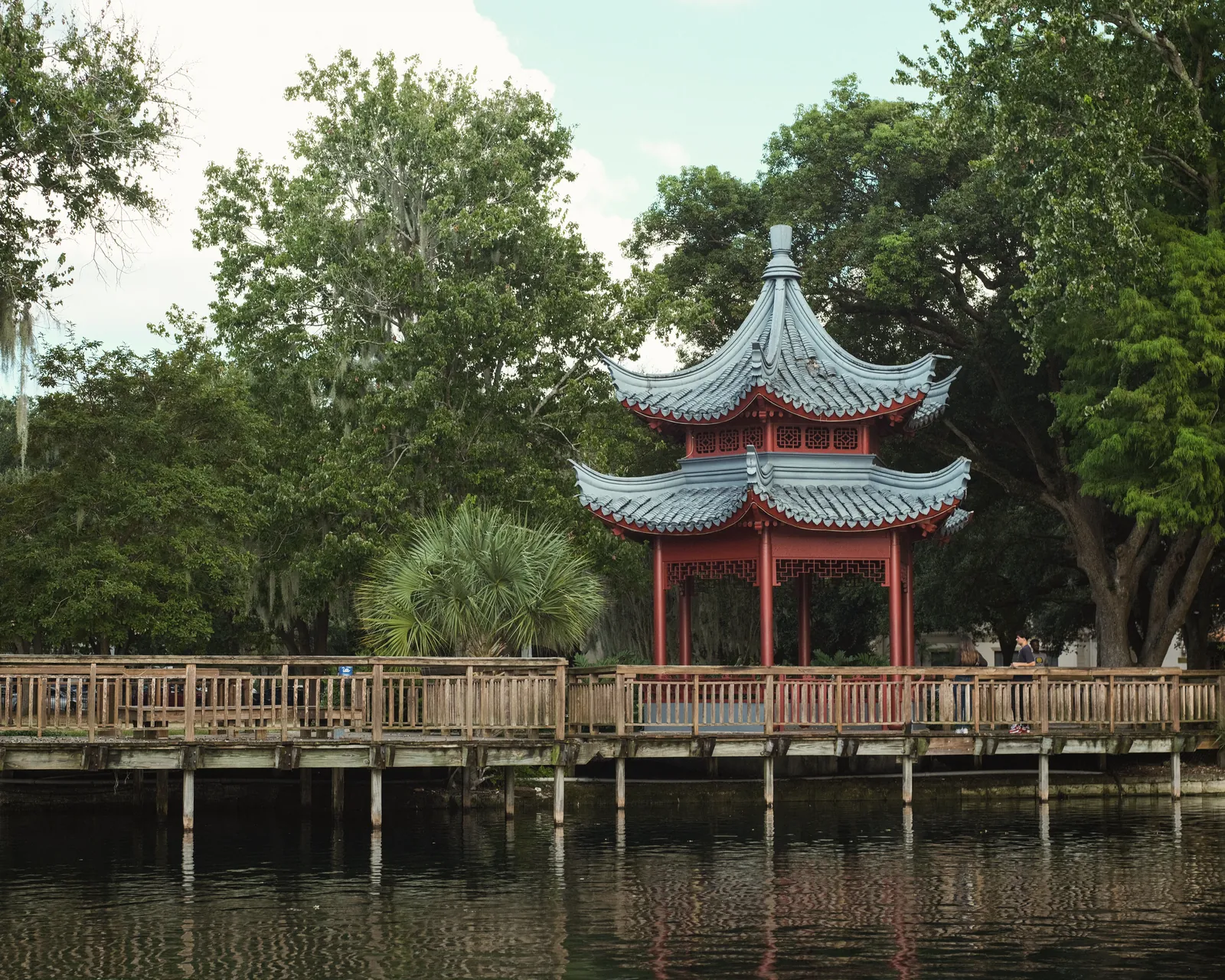Beautiful pagoda surrounded by lush greenery at Lake Eola, a serene travel destination.