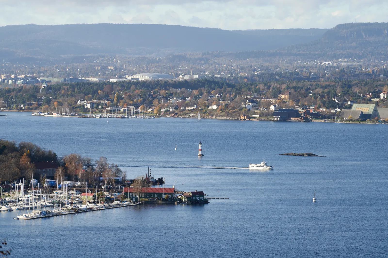 Breathtaking view of Oslo Fjord with marina and cityscape in the background, showcasing watercraft and landscape.