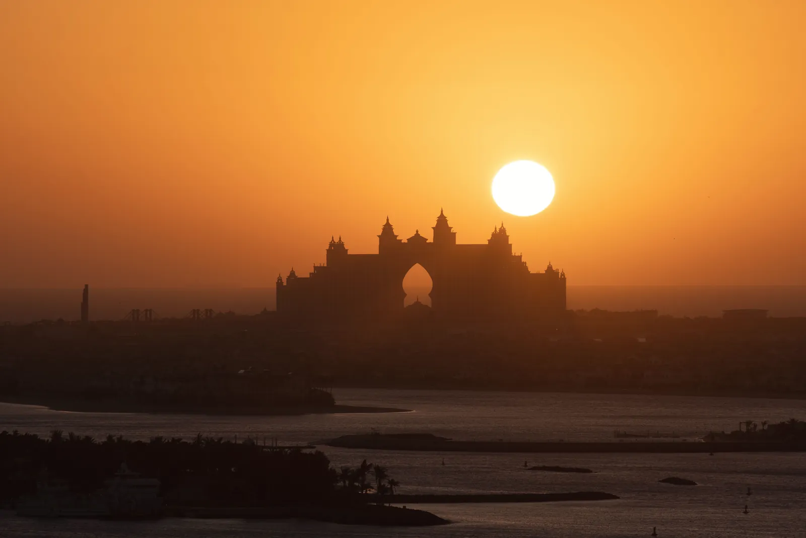 Silhouette of Atlantis The Palm against a vivid sunset in Dubai.