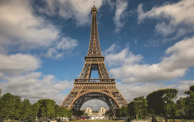 A breathtaking view of the Eiffel Tower against a blue sky in Paris, France.