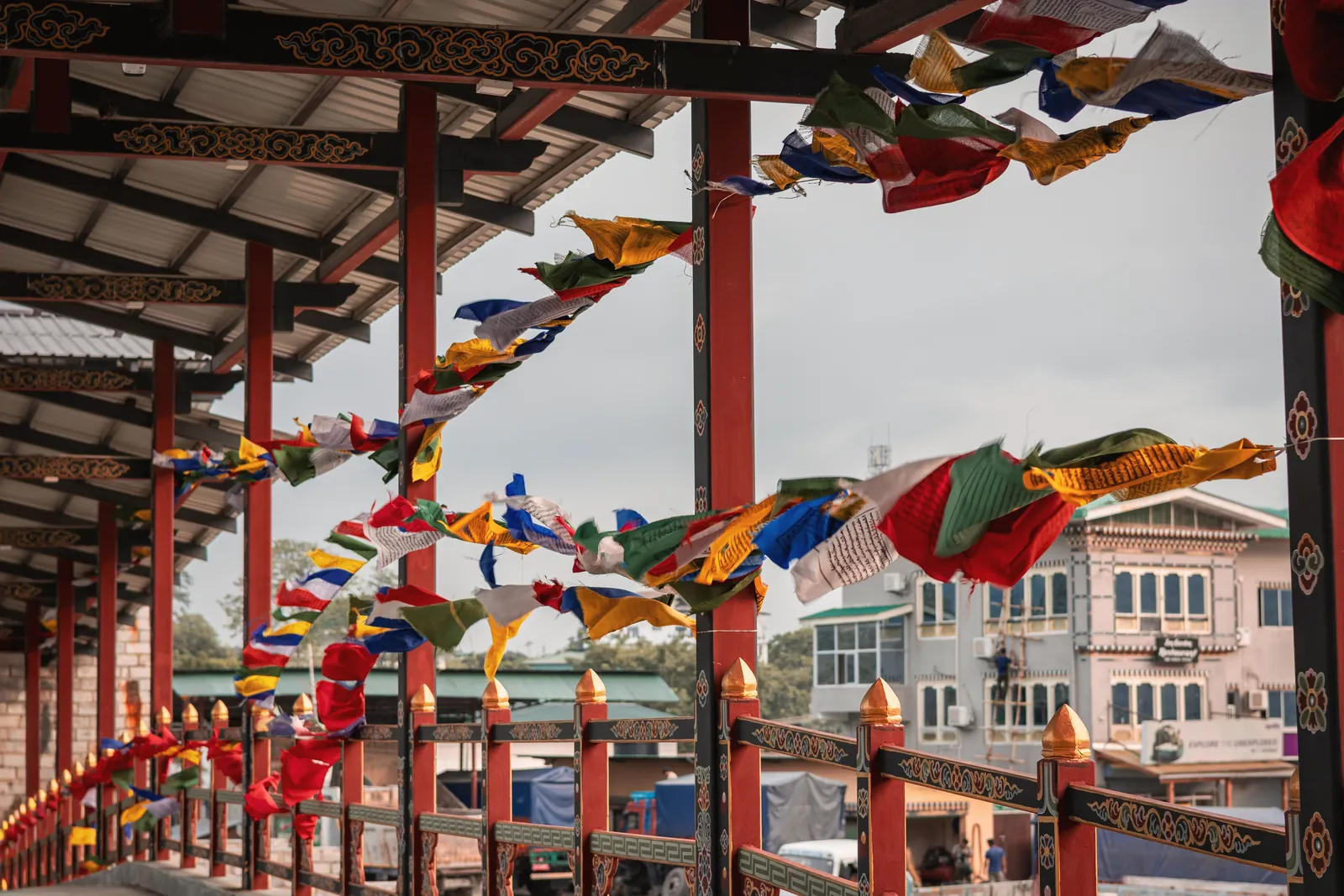 Colorful Bhutanese prayer flags blowing in the wind at a monastery corridor in Phuentsholing.