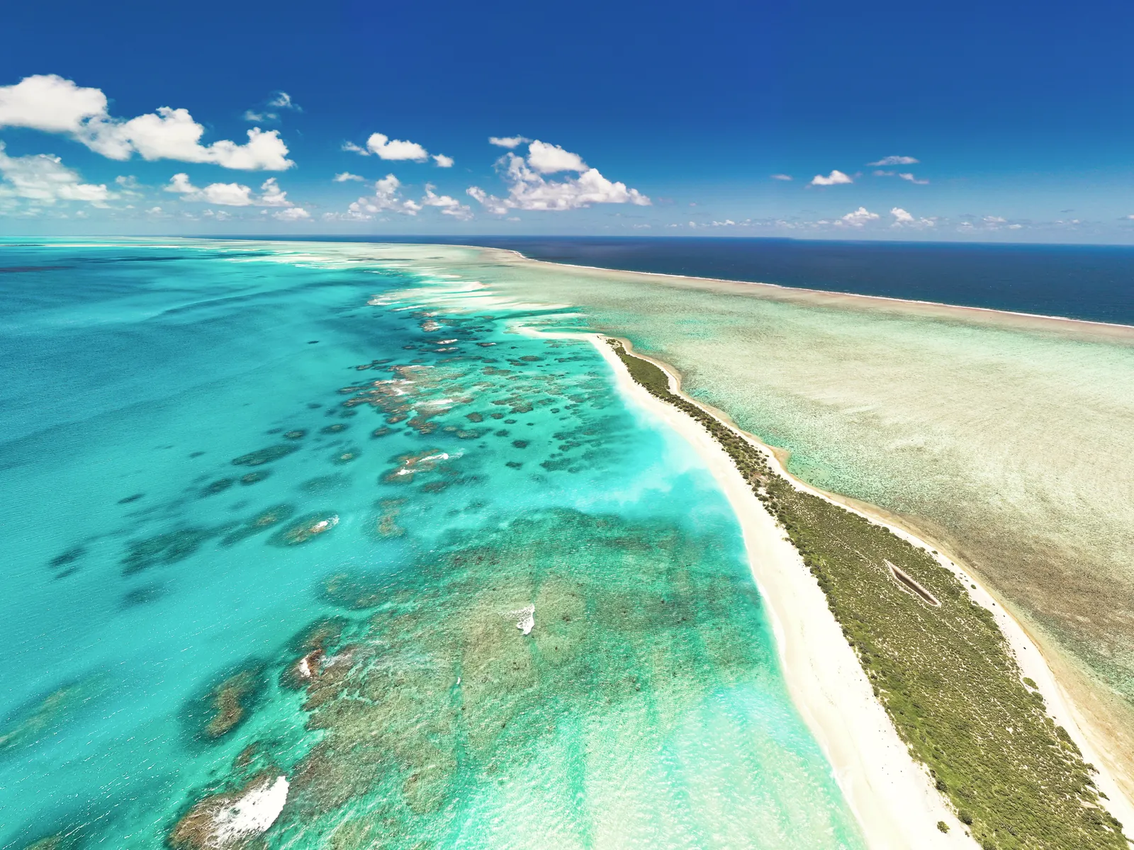 Stunning aerial shot capturing the vibrant turquoise waters and beautiful sandbars around Mauritius.