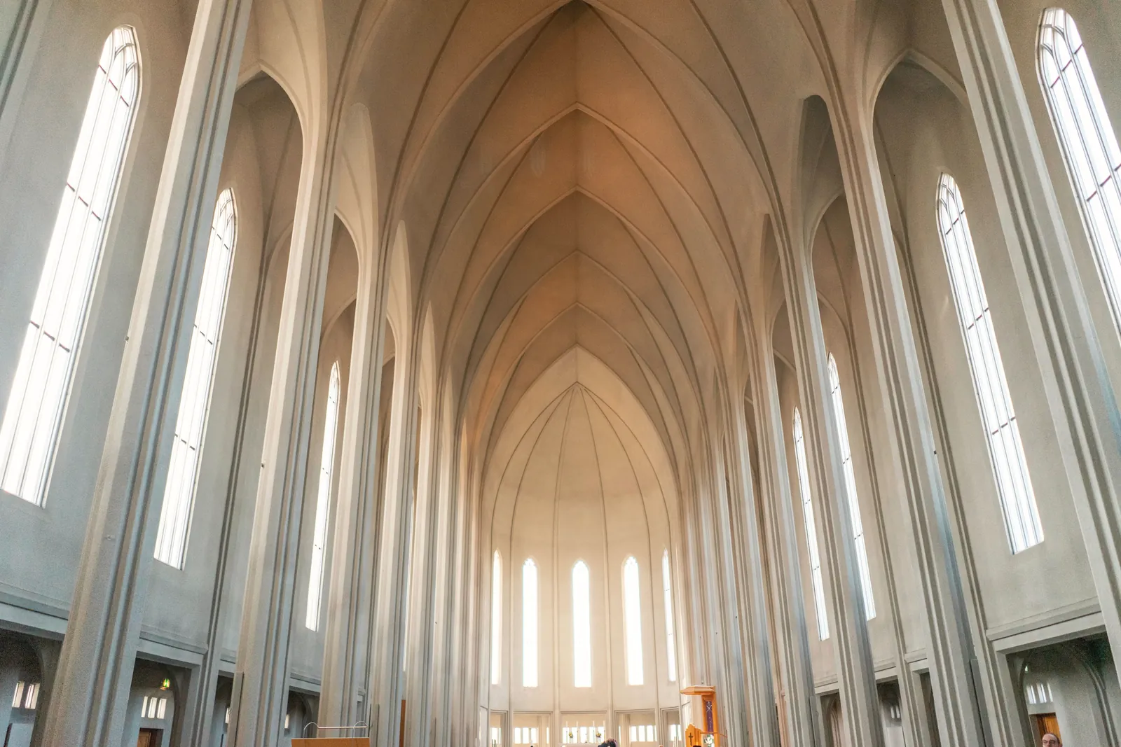 Majestic interior view of Hallgrimskirkja church with tall arches and high ceiling in Reykjavik, Iceland.