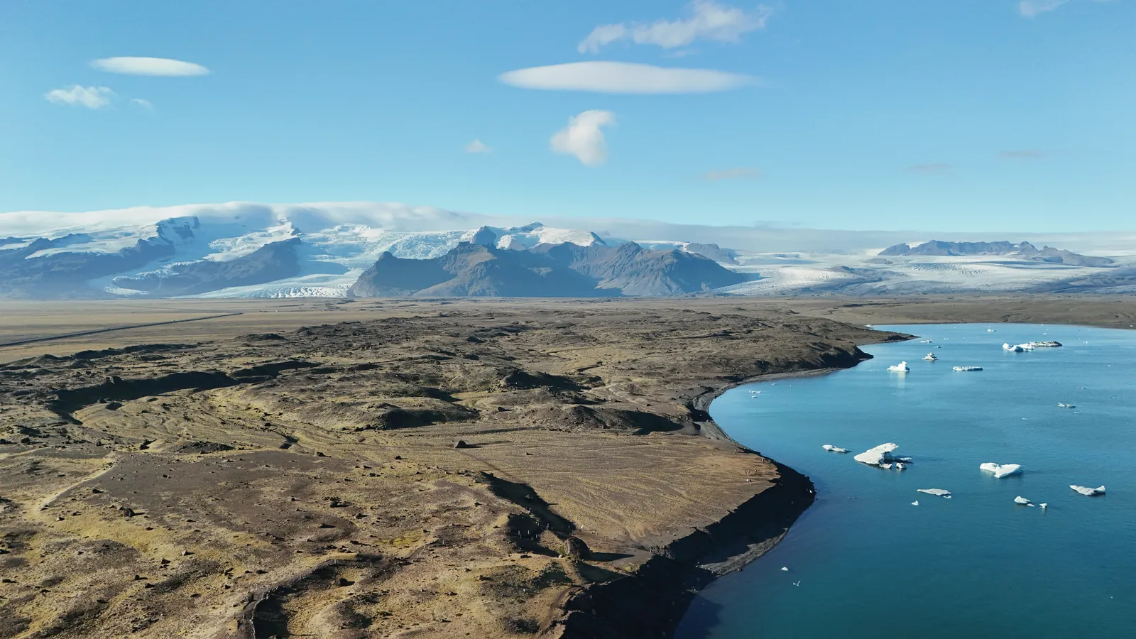 Stunning aerial view of Iceland's glacier and lake showcasing natural beauty and ice formations.