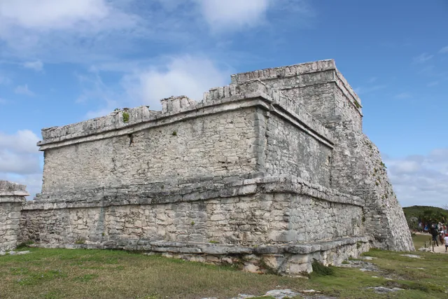 Explore the historic Mayan ruins at Tulum in Mexico, showcasing ancient stone architecture under a clear blue sky.