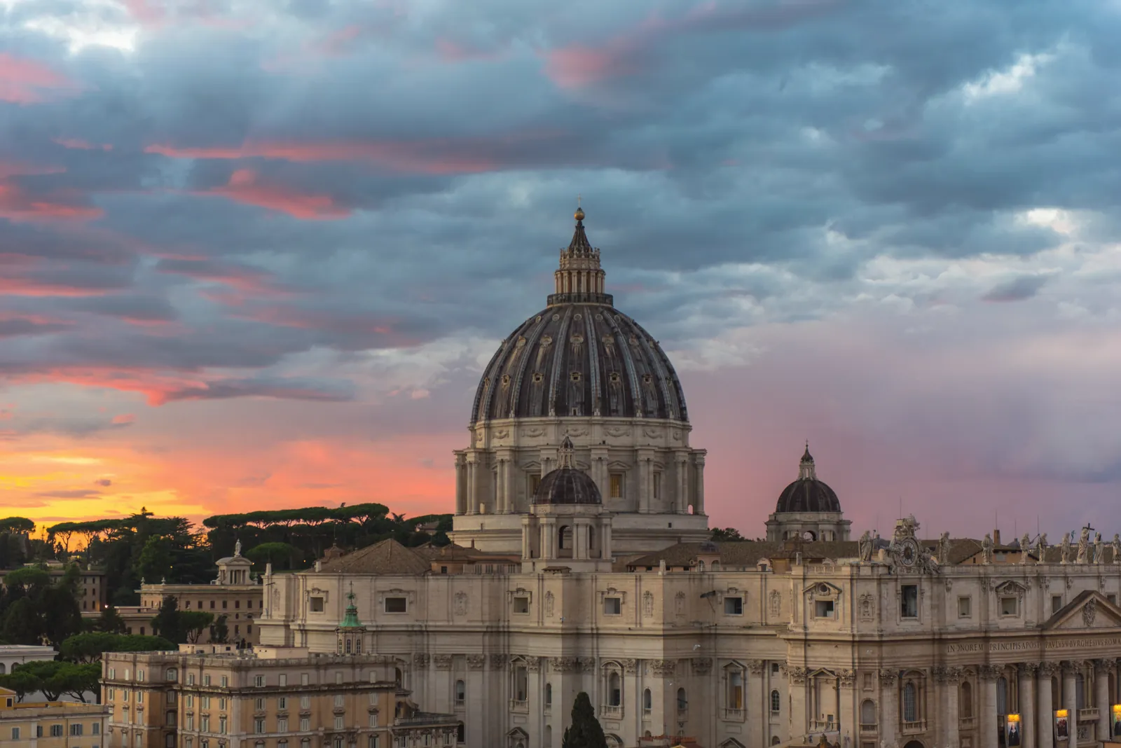 Beautiful view of St. Peter's Basilica surrounded by a vibrant sunset sky.