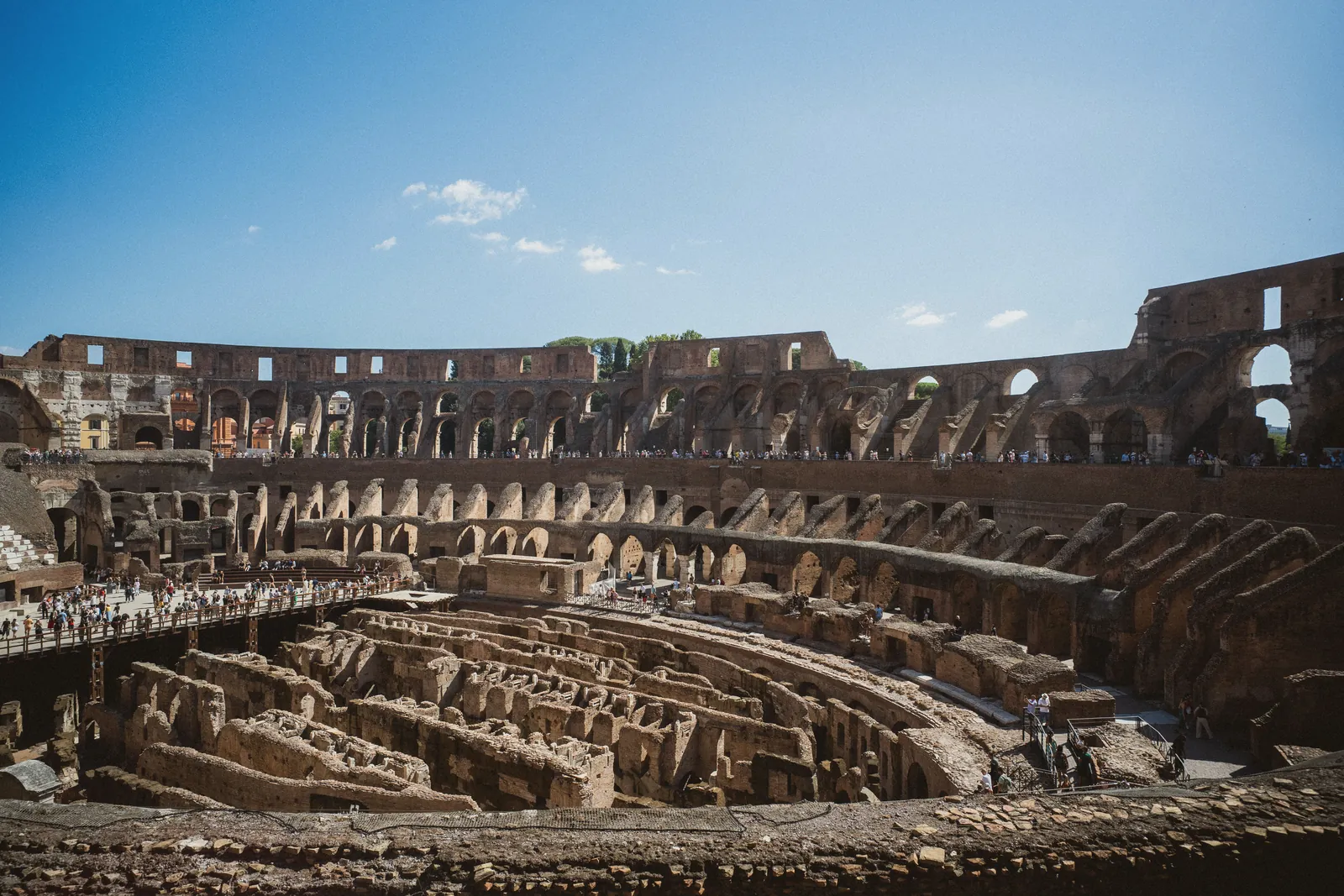 Explore the iconic Colosseum in Rome under a clear blue sky. Perfect for travel inspiration.