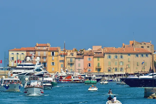 Elegant yachts in the vibrant harbor of Saint-Tropez under a clear blue sky.
