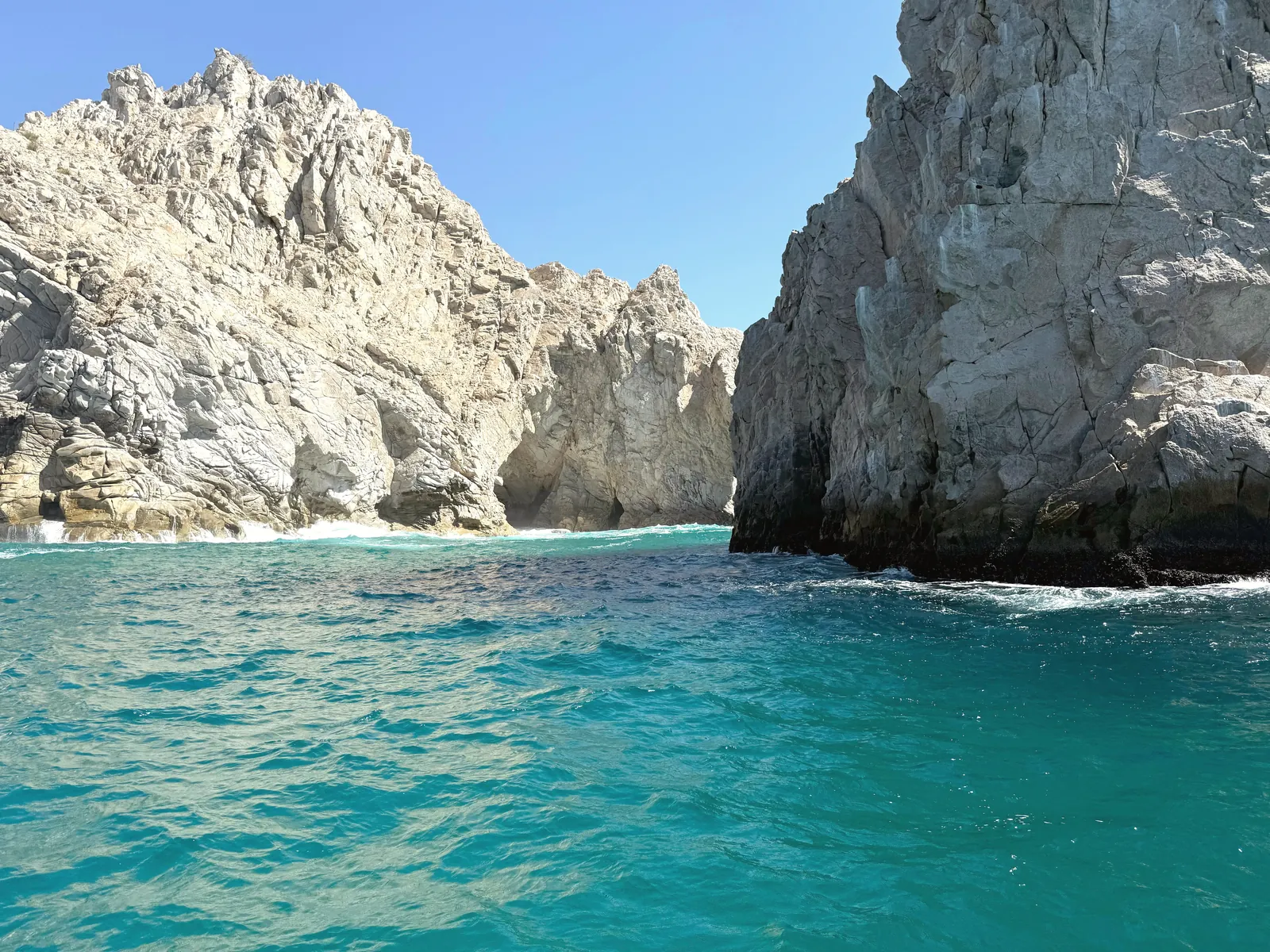 Stunning cliffs with turquoise waters in Cabo San Lucas, perfect for travel inspiration.