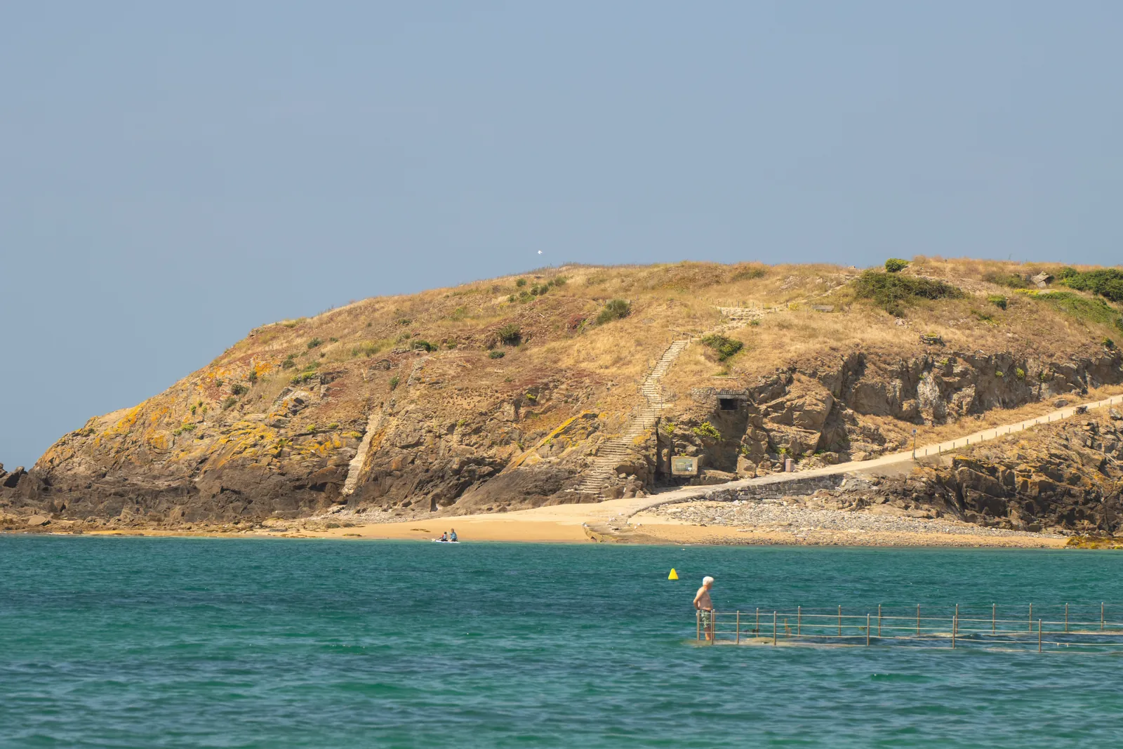 A captivating view of a beach and rocky coast at Saint-Malo, Brittany, France.