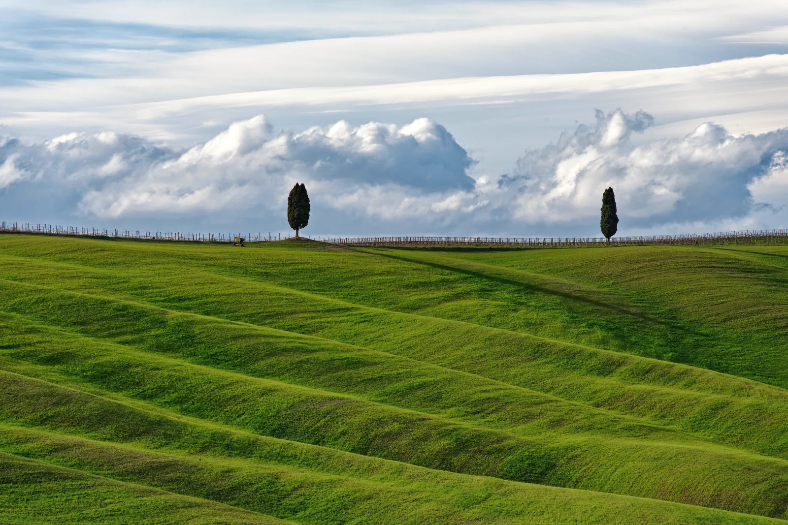 Beautiful rolling hills in Tuscany, Italy with dramatic clouds in the background.