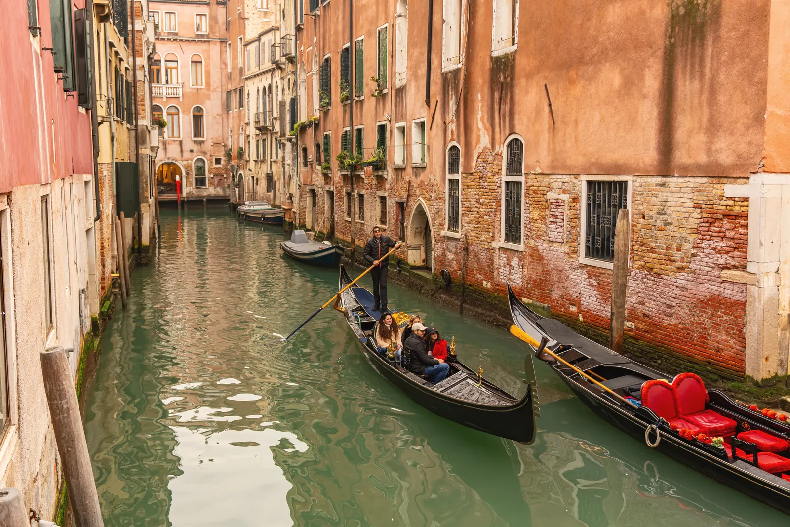 Gondolas on a charming Venetian canal surrounded by historic architecture in Venice, Italy.