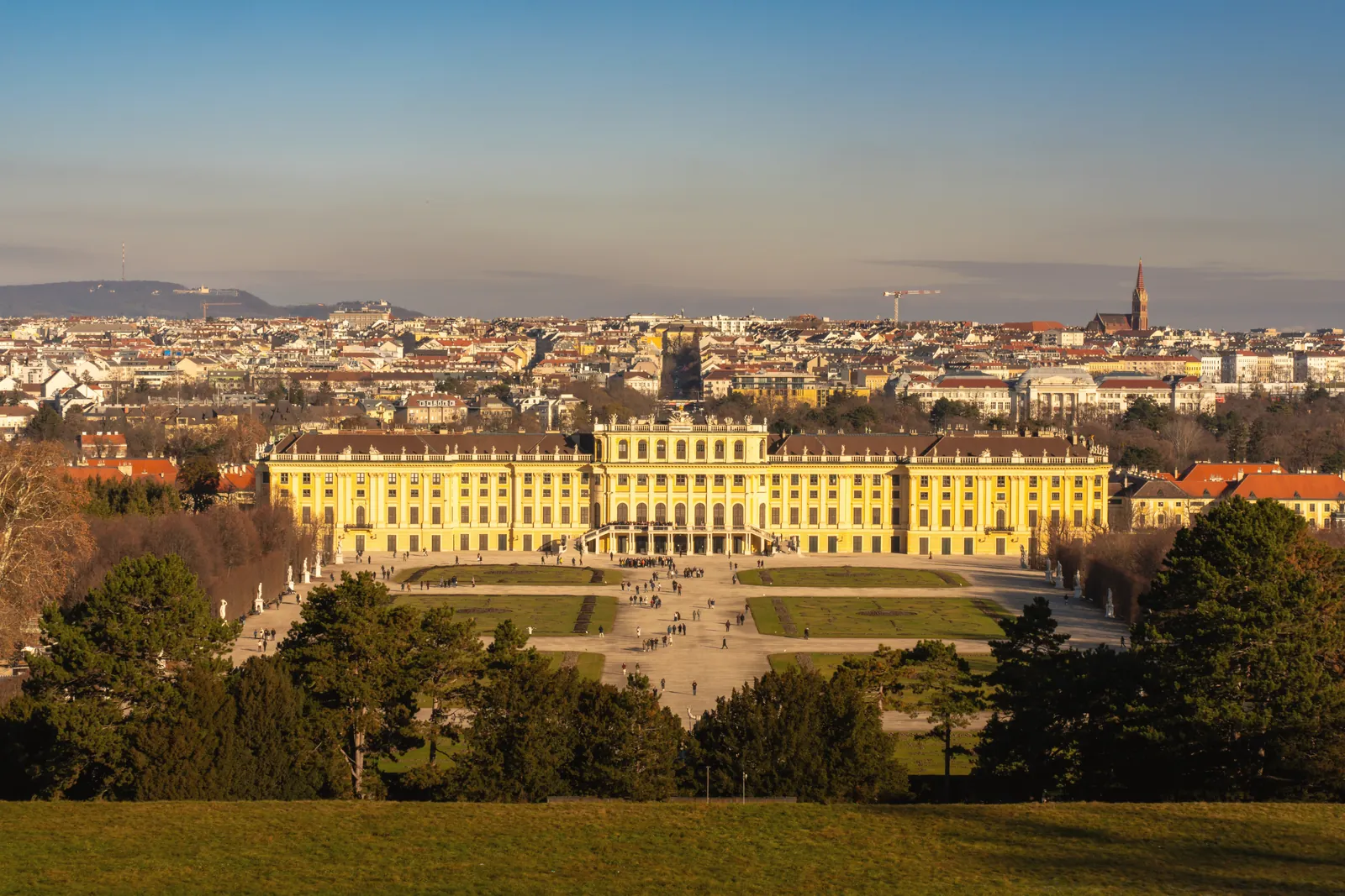 Panoramic view of Schonbrunn Palace in Vienna, Austria under a clear daytime sky.