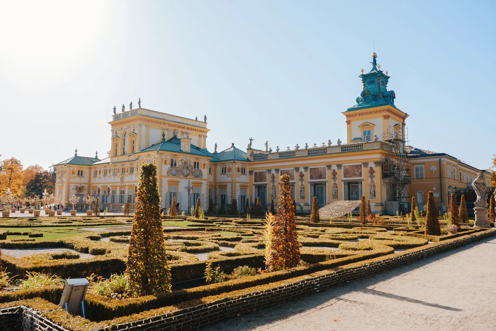 Sunlit view of the historic Wilanów Palace and its baroque gardens in Warsaw, Poland.