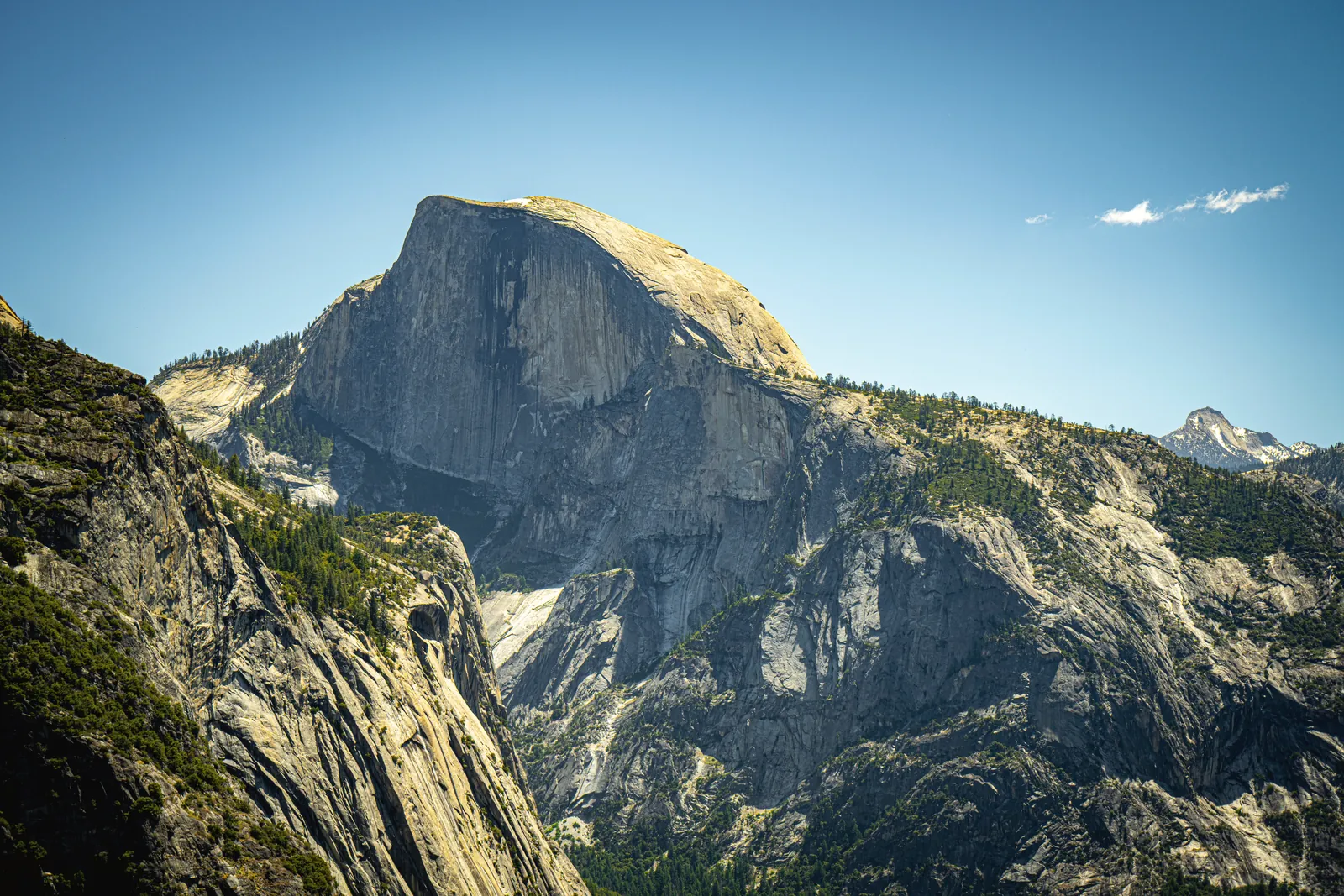 Captivating landscape of Half Dome in Yosemite National Park, under a clear blue sky.